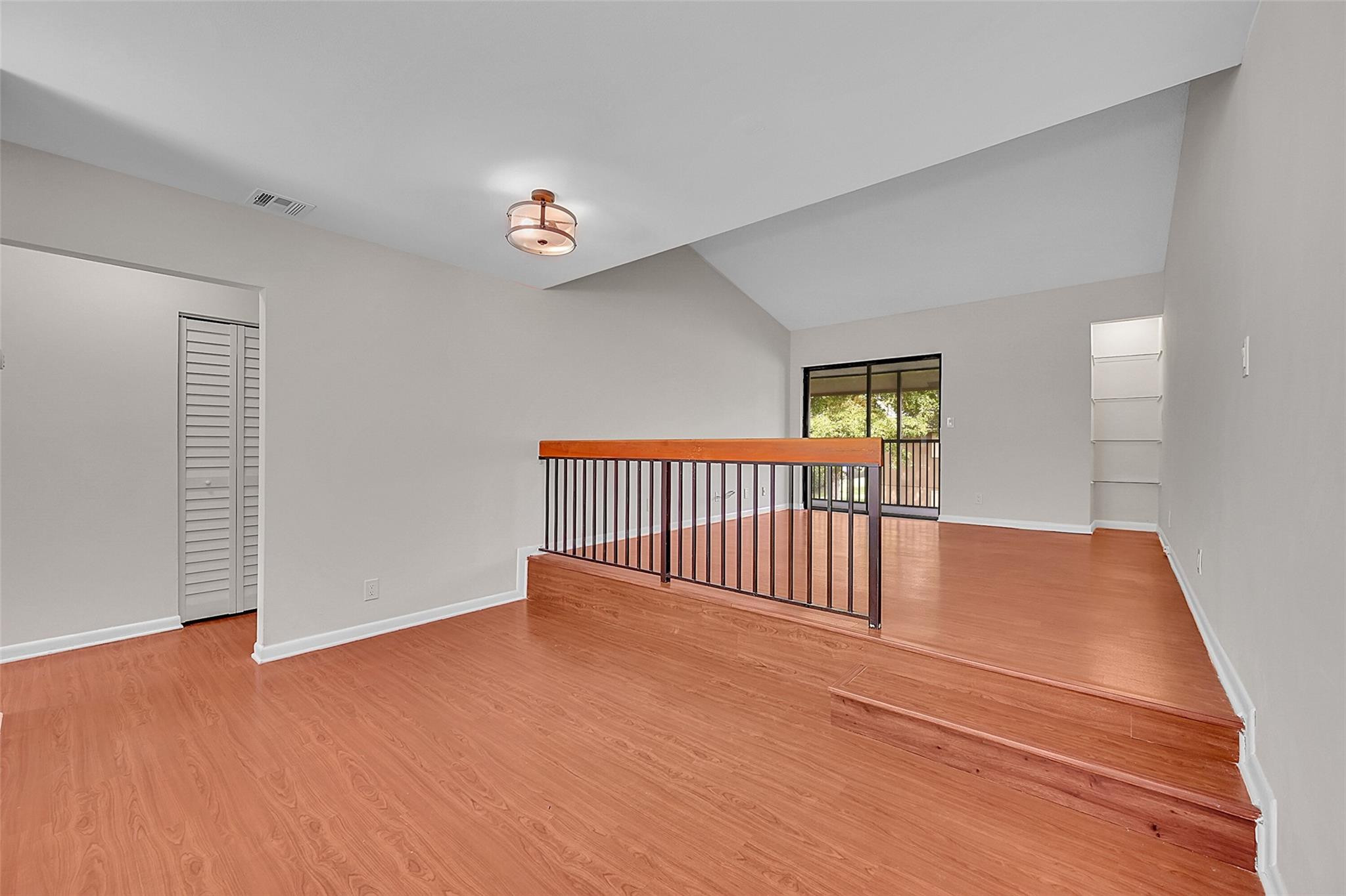 2578 Riverside Drive, Unit 421 Coral Springs, FL 33065 - Photo 6 of 29 a view of a hallway with wooden floor and windows
