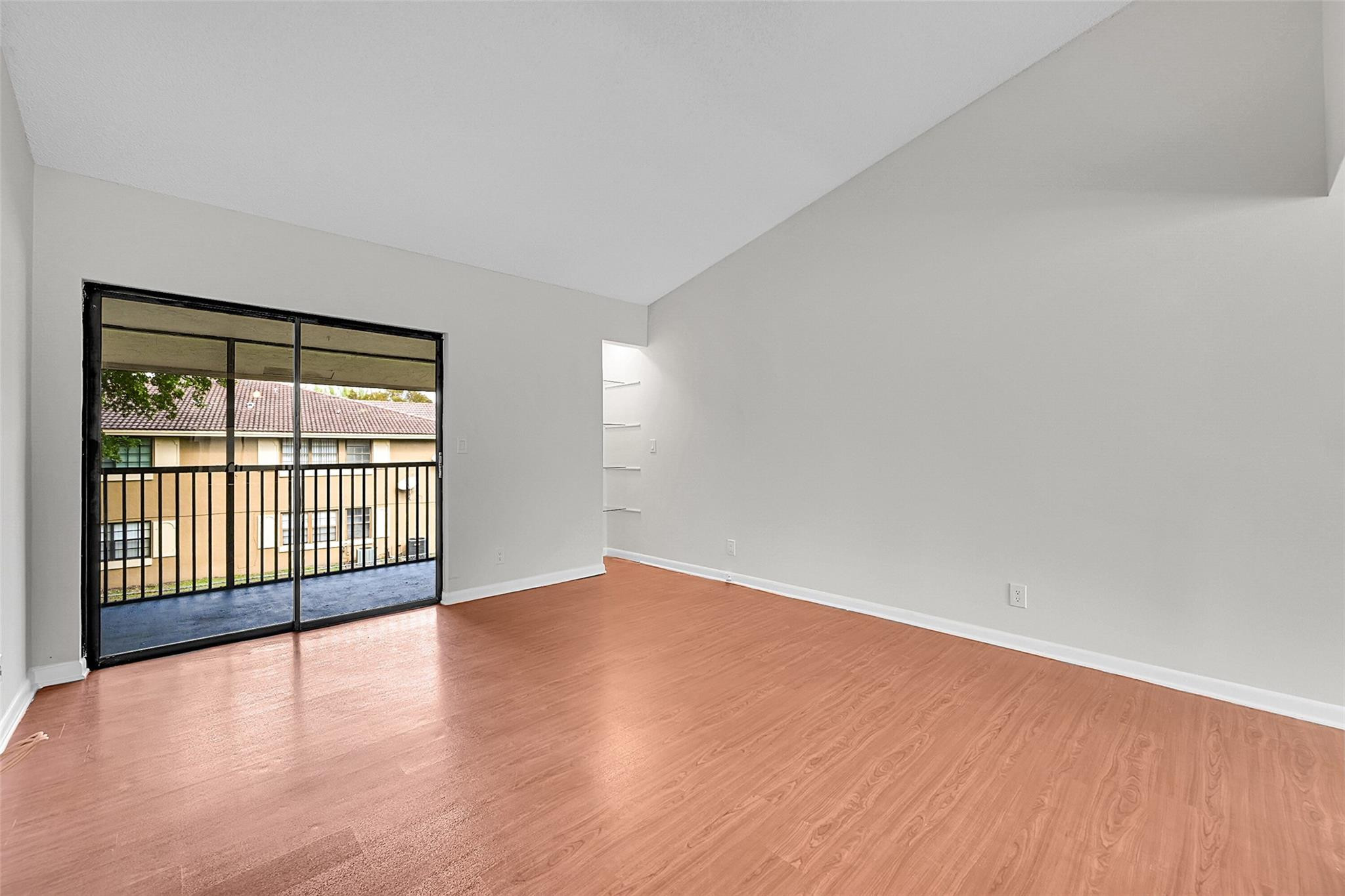 2578 Riverside Drive, Unit 421 Coral Springs, FL 33065 - Photo 8 of 29 wooden floor in an empty room with a window
