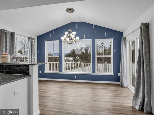 a kitchen with stainless steel appliances granite countertop a sink a stove a microwave and island