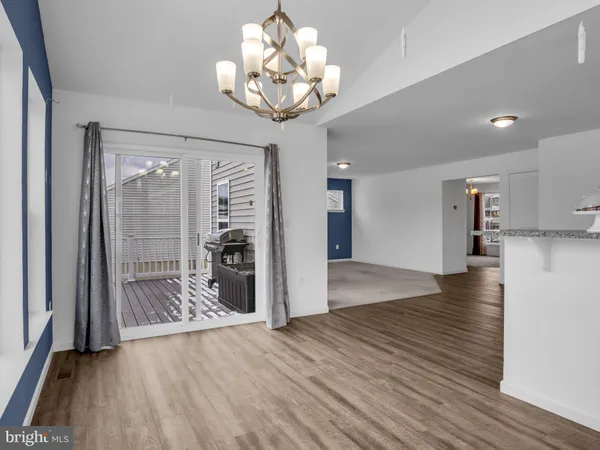 a kitchen with granite countertop a sink a counter space appliances and cabinets