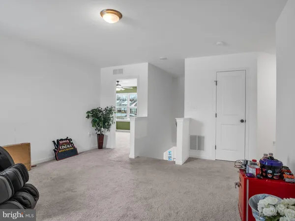 an empty room with closet and a chandelier fan