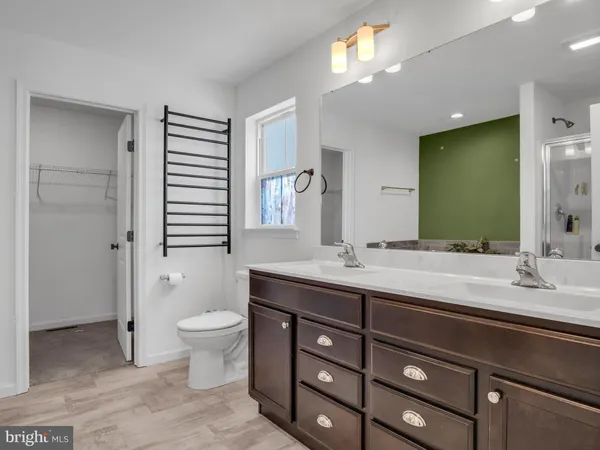 a front view of a house with a dirt road