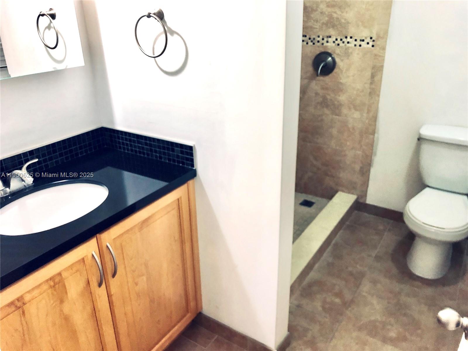 10440 Southwest 156th Court, Unit 712 Miami, FL 33196 - Photo 4 of 11 a bathroom with a sink and a mirror