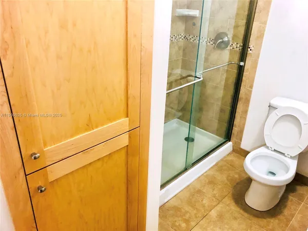 a bathroom with a toilet and a shower