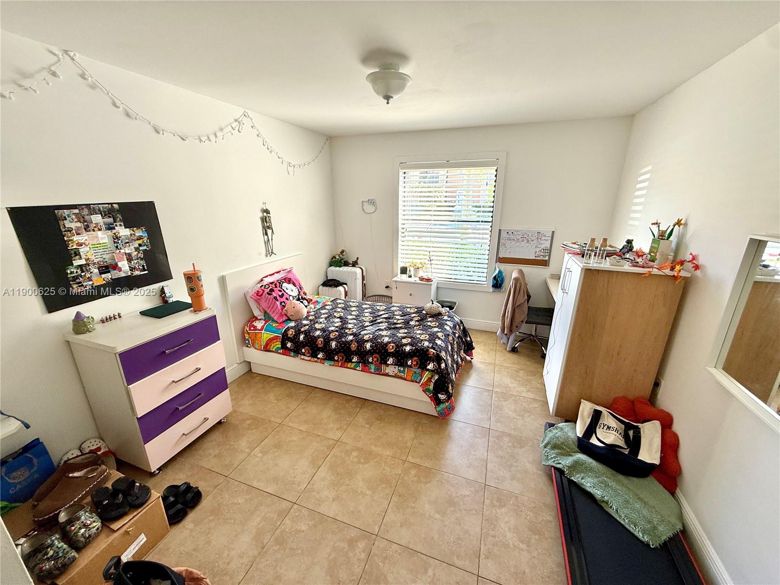 10440 Southwest 156th Court, Unit 712 Miami, FL 33196 - Photo 9 of 11 a bedroom with furniture and a window