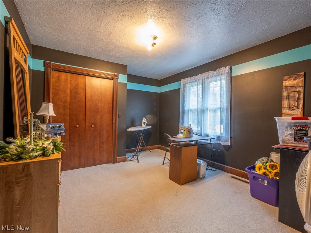 9452 Pleasant Hill Road Northwest Dundee, OH 44624 - Photo 26 of 35 Carpeted office featuring a textured ceiling