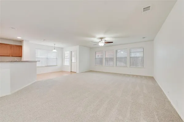 a view of an empty room with a ceiling fan