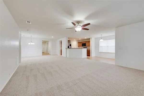 a view of an empty room with window and cabinet