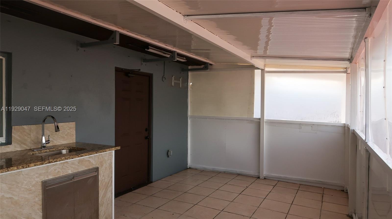 3109 Northwest 64th Street Miami, FL 33147 - Photo 13 of 38 a view of a kitchen from the hallway