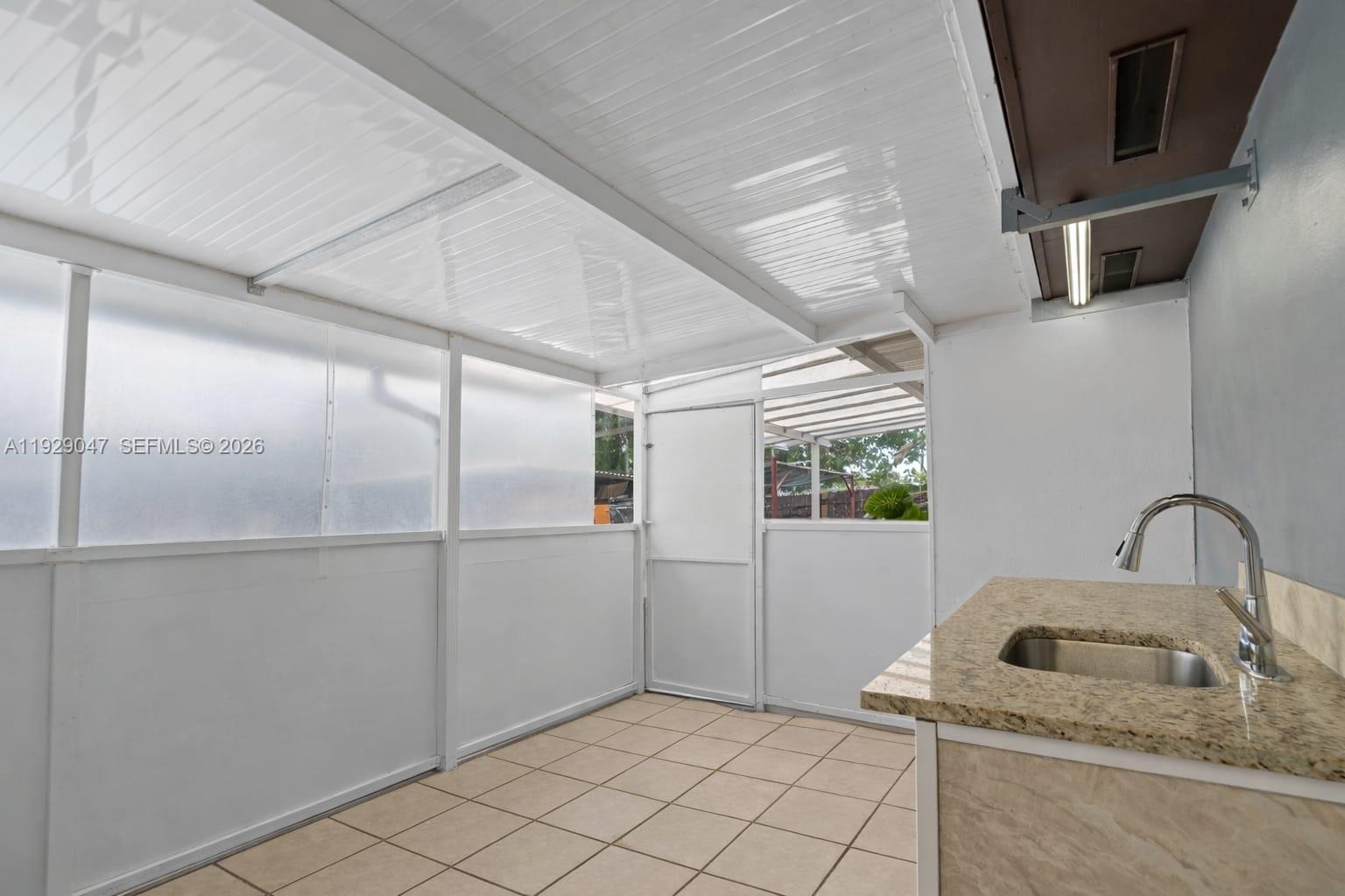 3109 Northwest 64th Street Miami, FL 33147 - Photo 13 of 20 a bathroom with a sink and washing machine