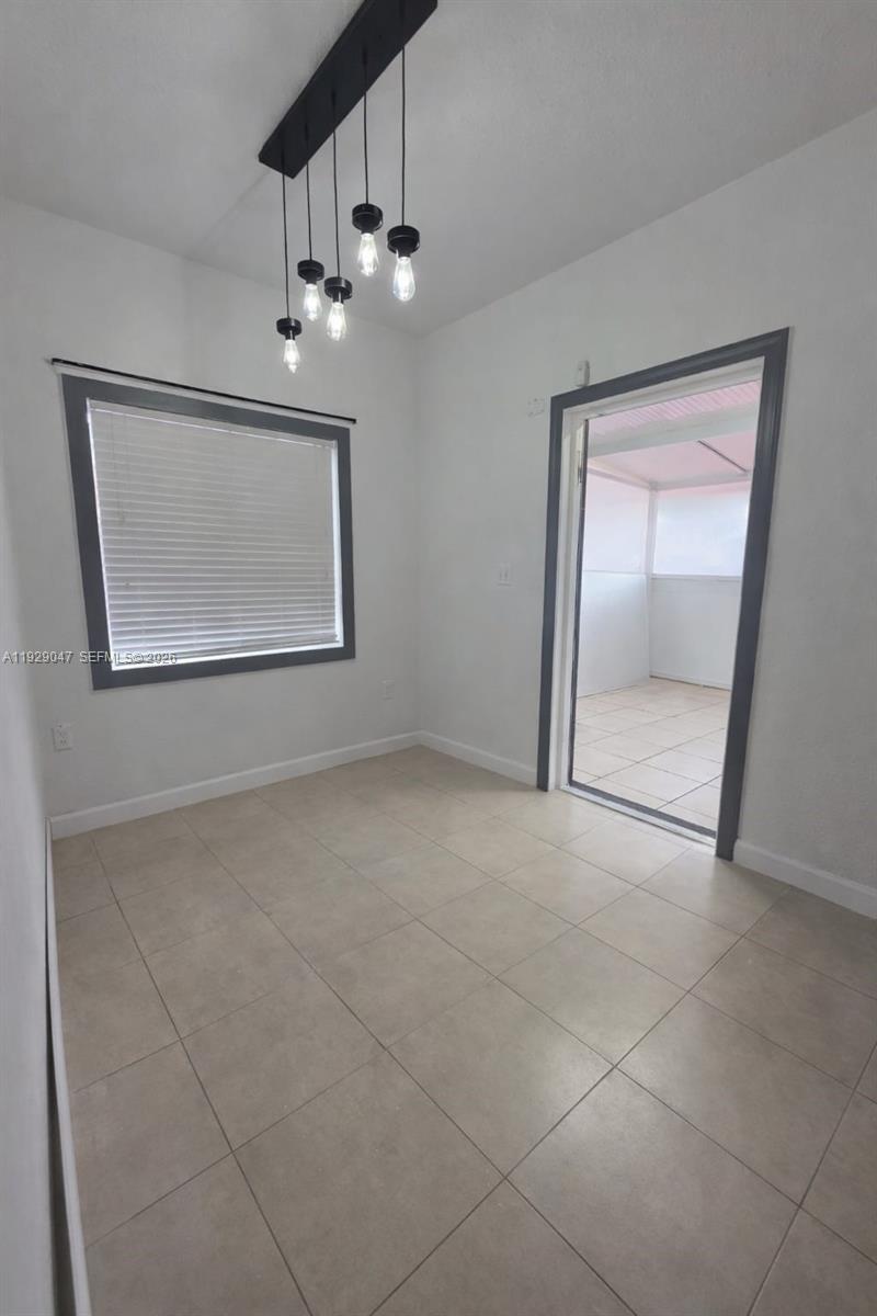 3109 Northwest 64th Street Miami, FL 33147 - Photo 14 of 20 a view of an empty room with a window