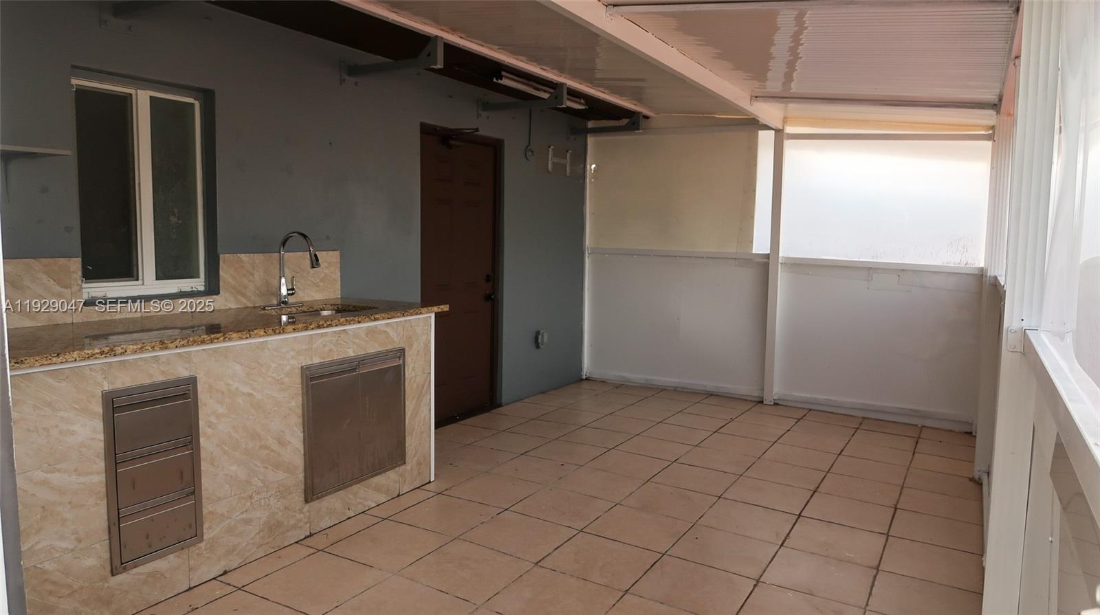 3109 Northwest 64th Street Miami, FL 33147 - Photo 15 of 38 a kitchen with a sink cabinets and a refrigerator