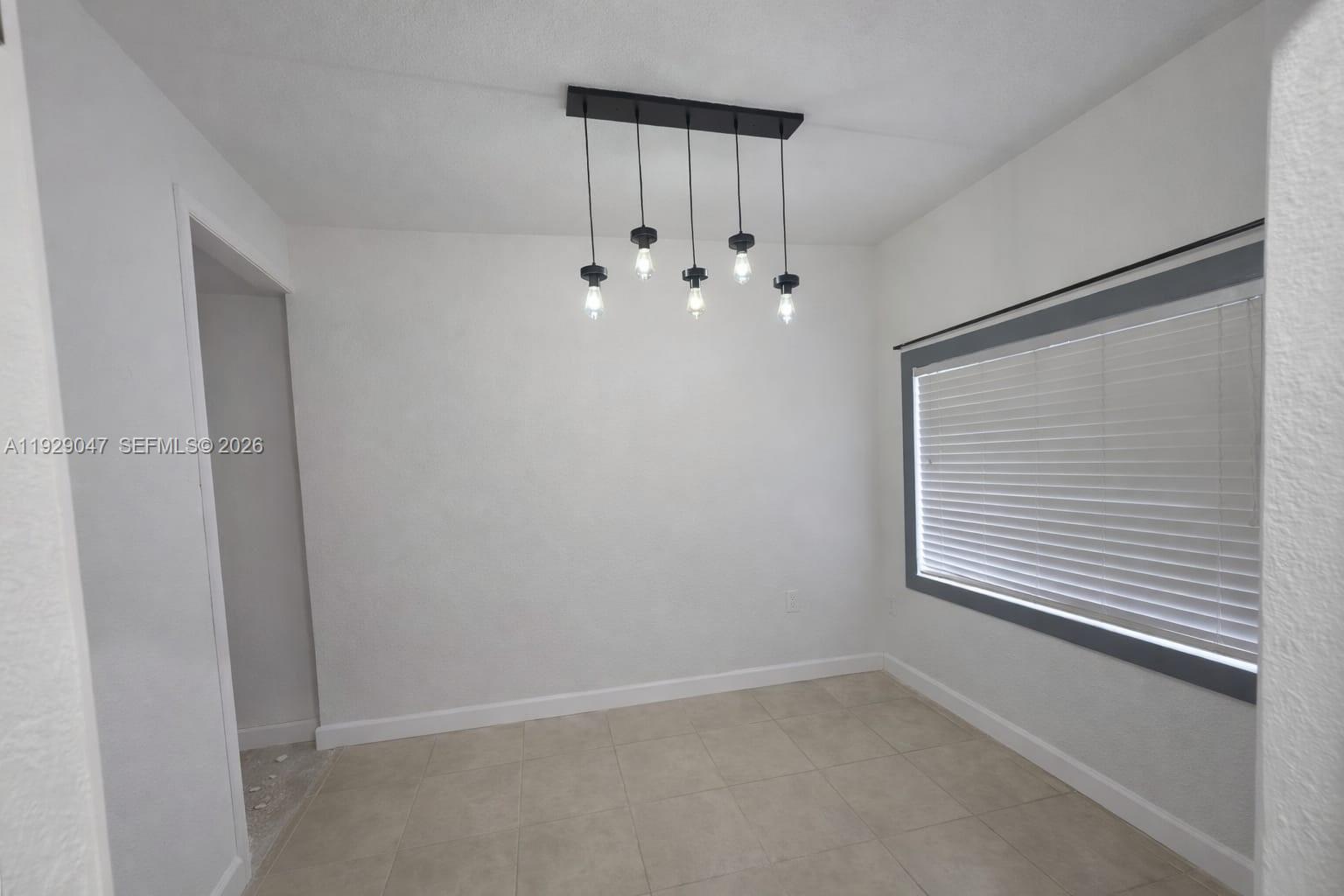 3109 Northwest 64th Street Miami, FL 33147 - Photo 16 of 20 a view of an empty room with a window