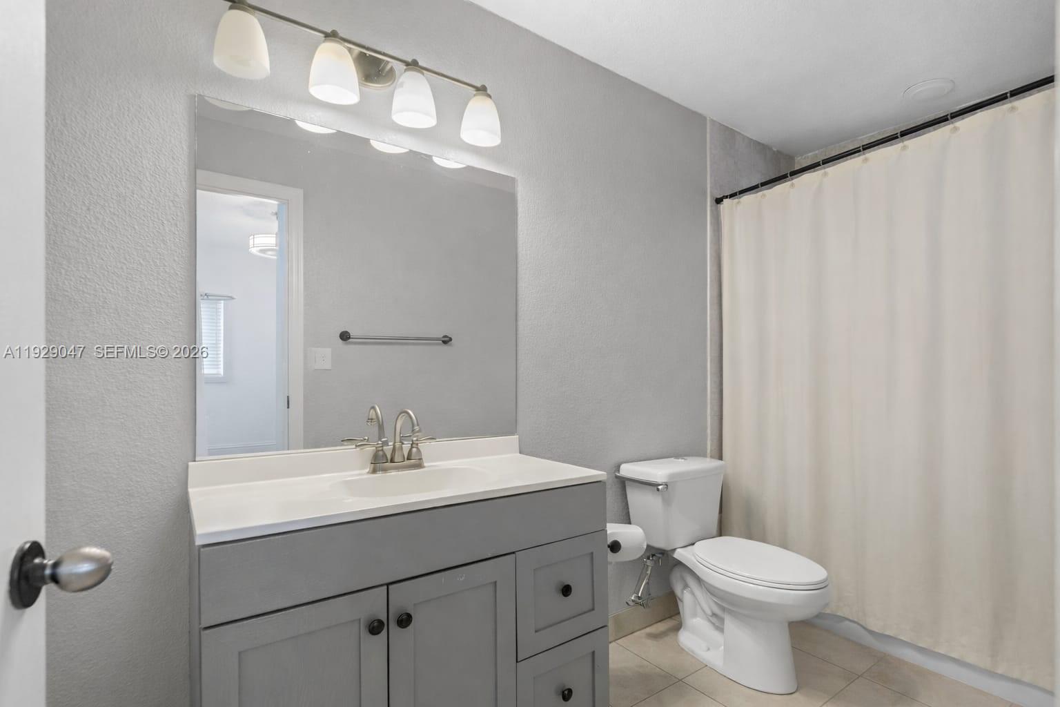 3109 Northwest 64th Street Miami, FL 33147 - Photo 3 of 20 a bathroom with a sink a toilet and shower