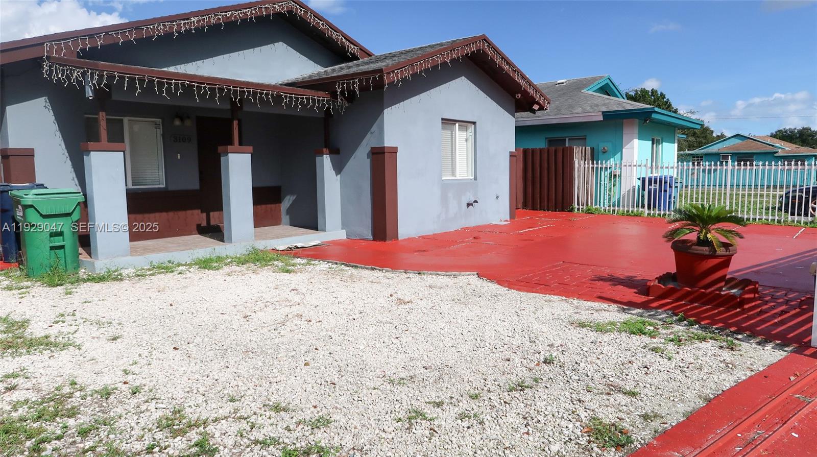 3109 Northwest 64th Street Miami, FL 33147 - Photo 3 of 38 a front view of a house with garden