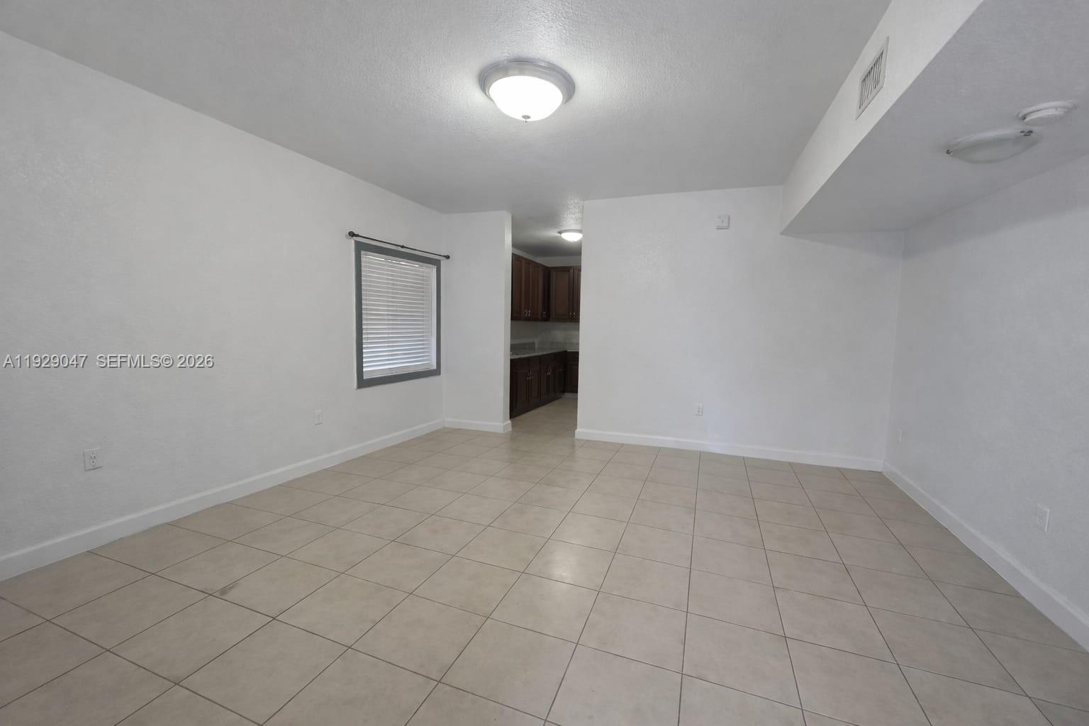 3109 Northwest 64th Street Miami, FL 33147 - Photo 4 of 20 an empty room with windows and entrance
