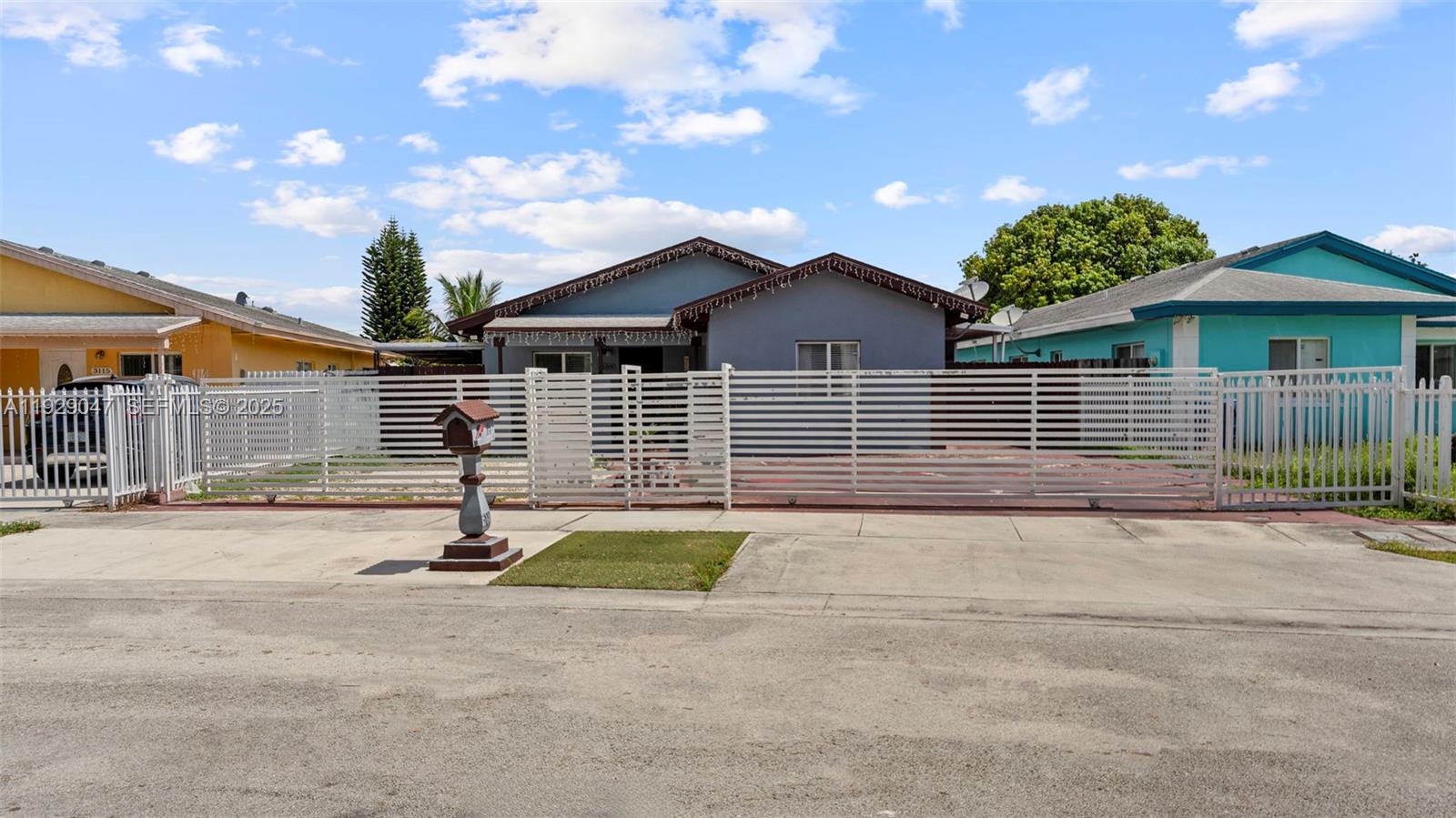 3109 Northwest 64th Street Miami, FL 33147 - Photo 4 of 38 a front view of a house with a yard and garage