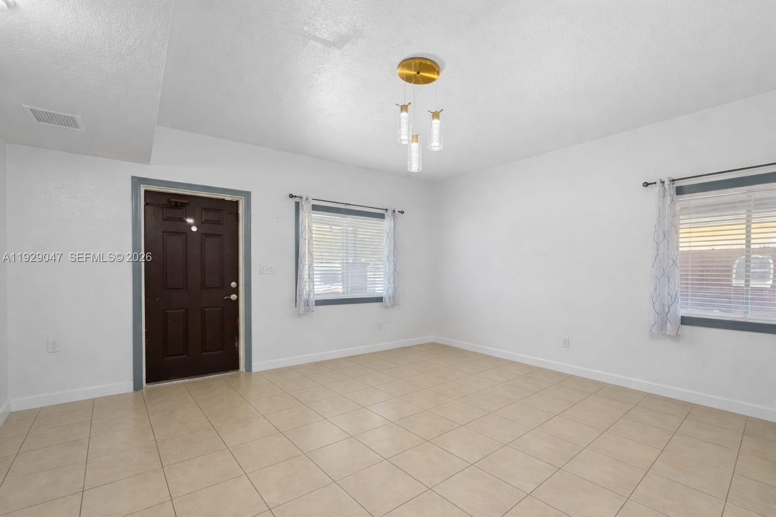 3109 Northwest 64th Street Miami, FL 33147 - Photo 5 of 20 an empty room with windows