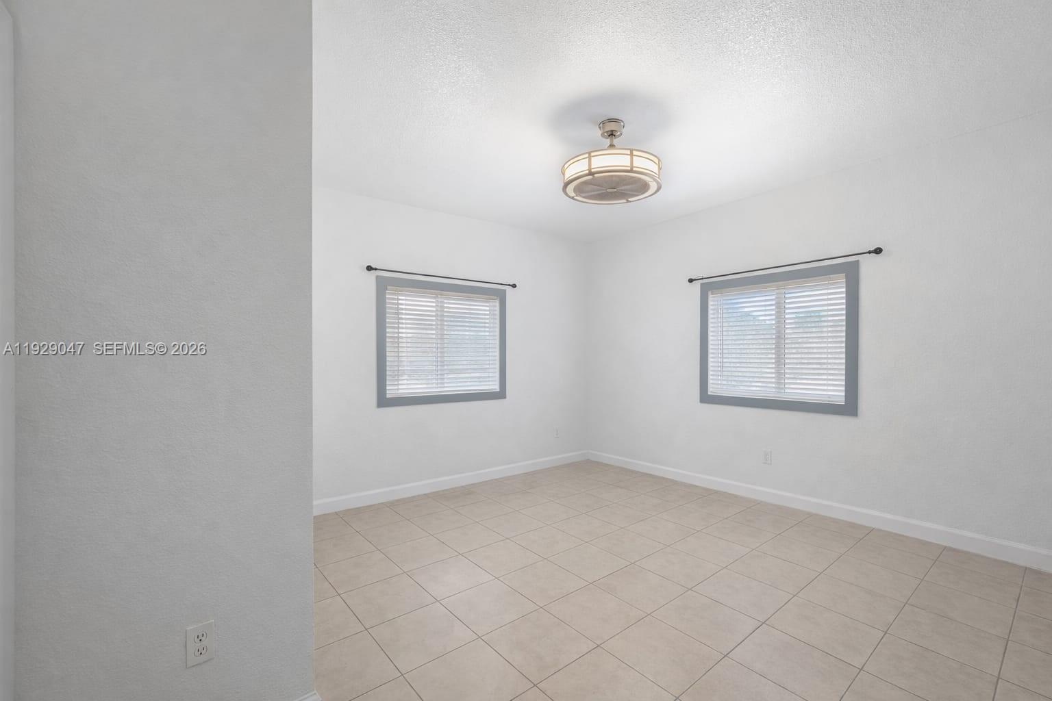 3109 Northwest 64th Street Miami, FL 33147 - Photo 7 of 20 an empty room with windows and fan