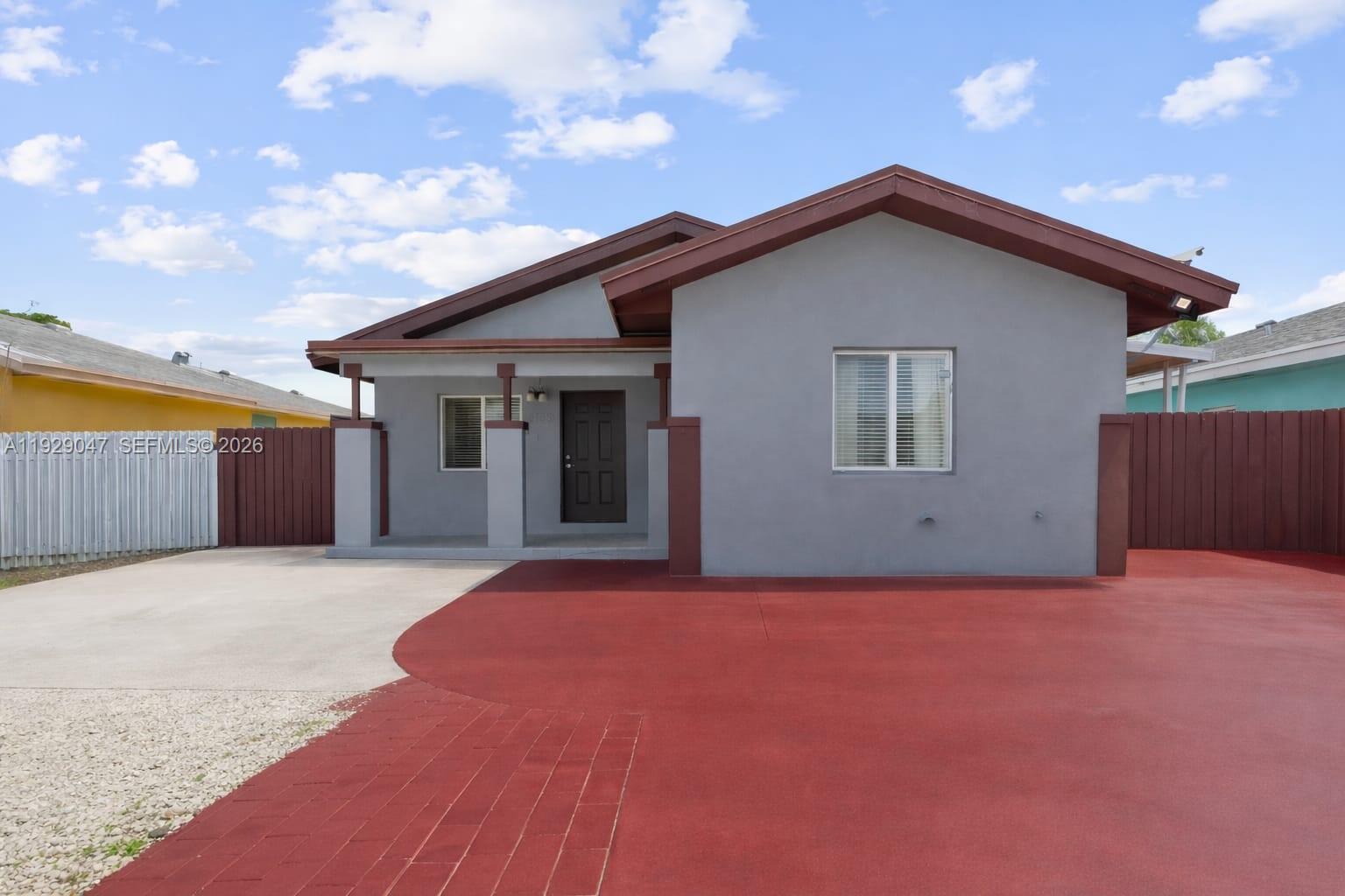 3109 Northwest 64th Street Miami, FL 33147 - Photo 8 of 20 a front view of house with yard and trees in the background