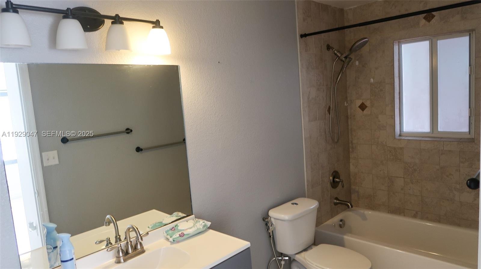 3109 Northwest 64th Street Miami, FL 33147 - Photo 8 of 38 a bathroom with a toilet a sink and shower