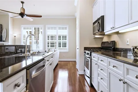 a large kitchen with granite countertop a lot of counter space