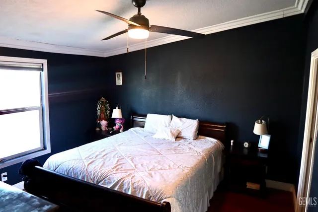 a bed sitting in a bedroom next to a window