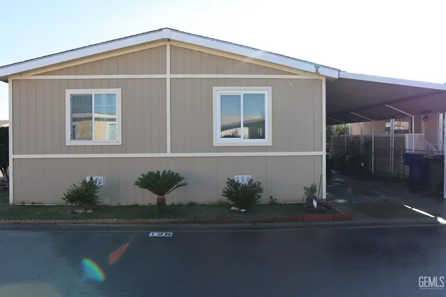 a front view of a house with potted plants