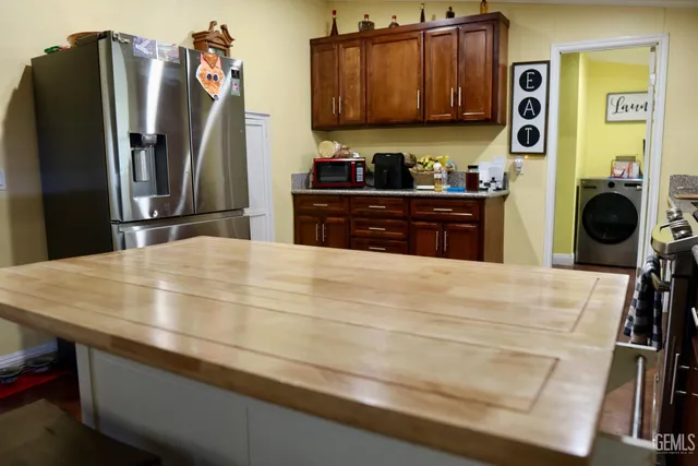 a kitchen with stainless steel appliances a refrigerator and a stove