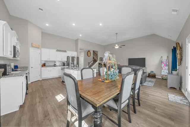 a view of a dining room with furniture and wooden floor