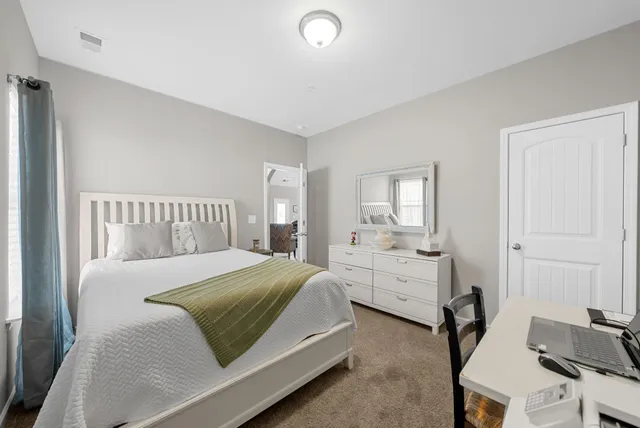 a bedroom with a bed and a window