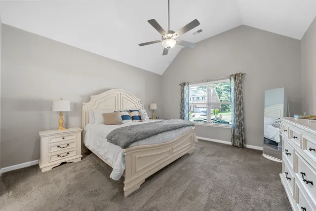 a spacious bedroom with a bed and a window