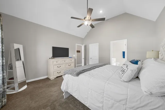 a bedroom with a bed and a flat tv screen on dresser