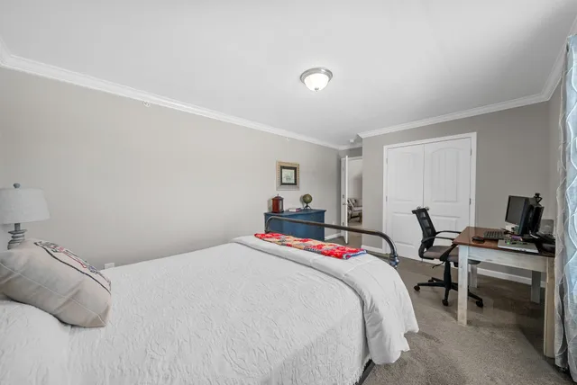 a bedroom with a bed and a desk