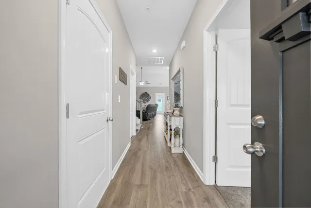 a view of a hallway with wooden floor