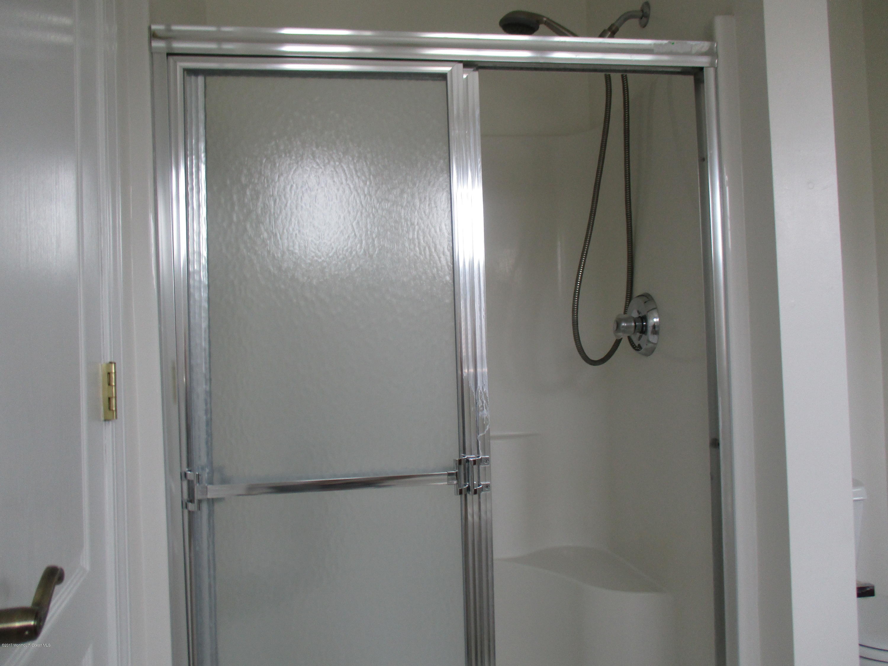 152 Barracuda Road Manahawkin, NJ 08050 - Photo 20 of 30 a bathroom with a glass shower door