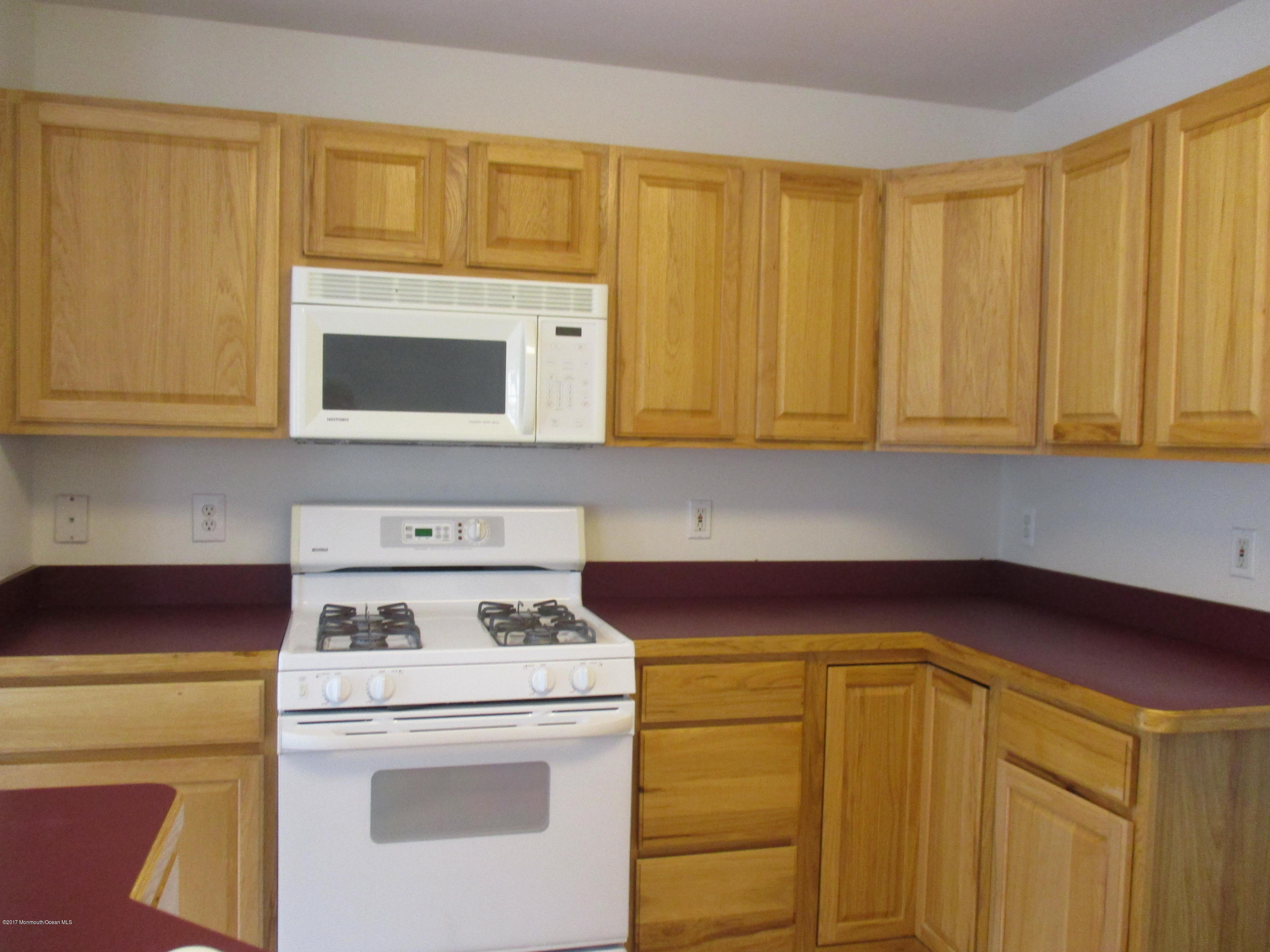 152 Barracuda Road Manahawkin, NJ 08050 - Photo 3 of 30 a kitchen with a stove and a microwave