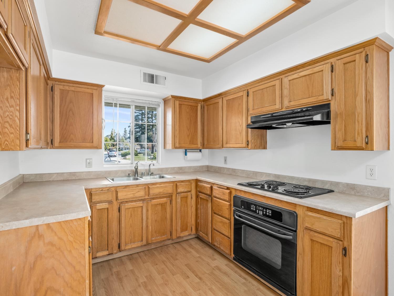 272 North Caesar Avenue Clovis, CA 93612 - Photo 12 of 34 a kitchen with stainless steel appliances granite countertop a sink stove and cabinets