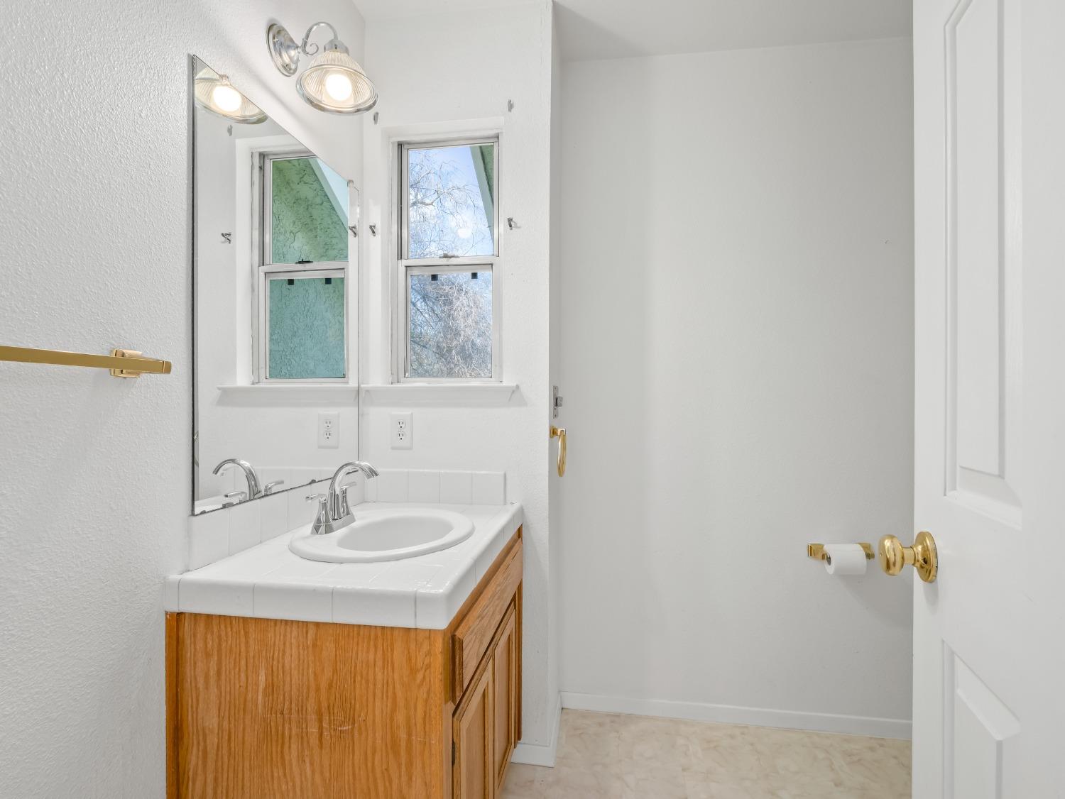 272 North Caesar Avenue Clovis, CA 93612 - Photo 14 of 34 a bathroom with a sink a vanity and a mirror