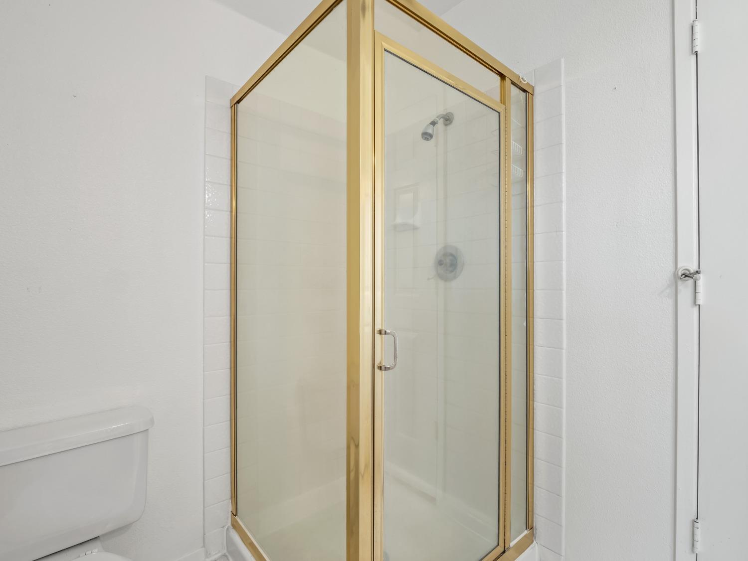 272 North Caesar Avenue Clovis, CA 93612 - Photo 15 of 34 a bathroom with a shower and a glass door