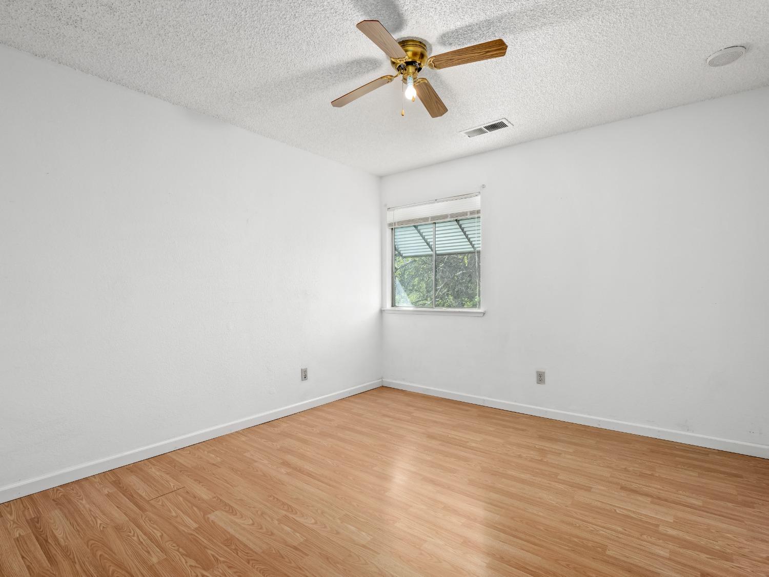 272 North Caesar Avenue Clovis, CA 93612 - Photo 19 of 34 an empty room with a window and a fan