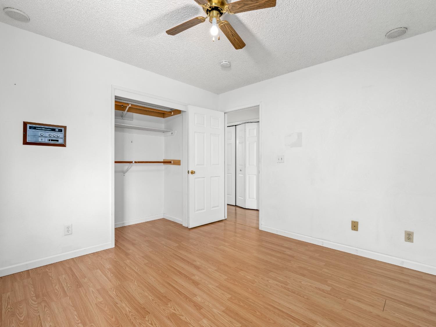 272 North Caesar Avenue Clovis, CA 93612 - Photo 20 of 34 a view of an empty room with wooden floor and a ceiling fan