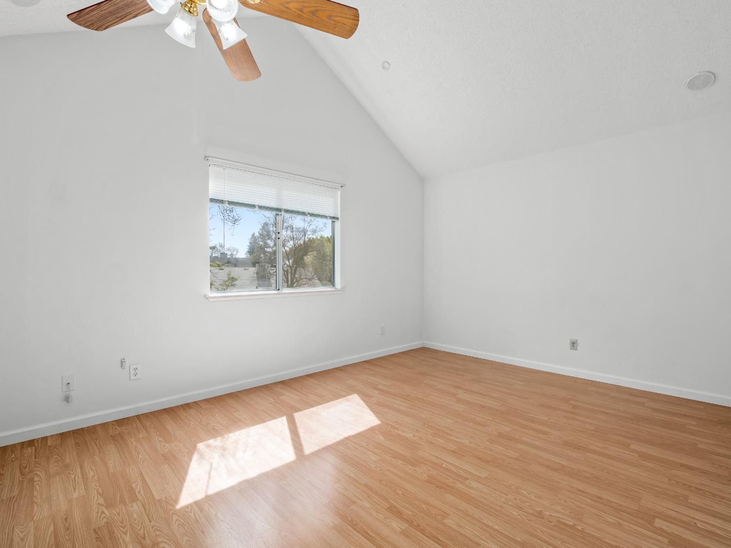 272 North Caesar Avenue Clovis, CA 93612 - Photo 21 of 34 an empty room with wooden floor chandelier fan and windows