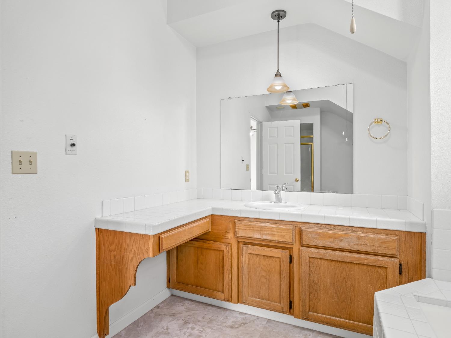 272 North Caesar Avenue Clovis, CA 93612 - Photo 25 of 34 a view of a kitchen with granite countertop white cabinets and a chandelier