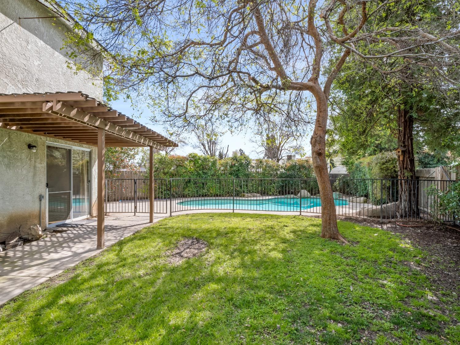 272 North Caesar Avenue Clovis, CA 93612 - Photo 30 of 34 a view of a house with a backyard and a tree