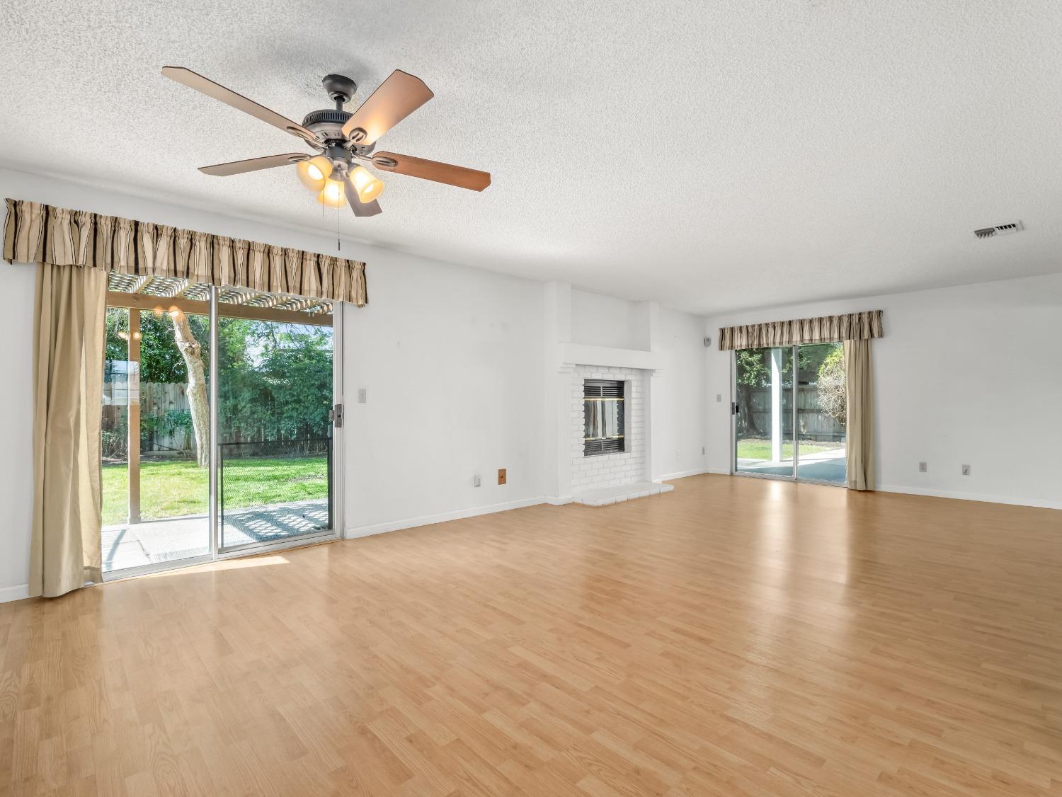 272 North Caesar Avenue Clovis, CA 93612 - Photo 10 of 34 a view of an empty room with wooden floor and a window
