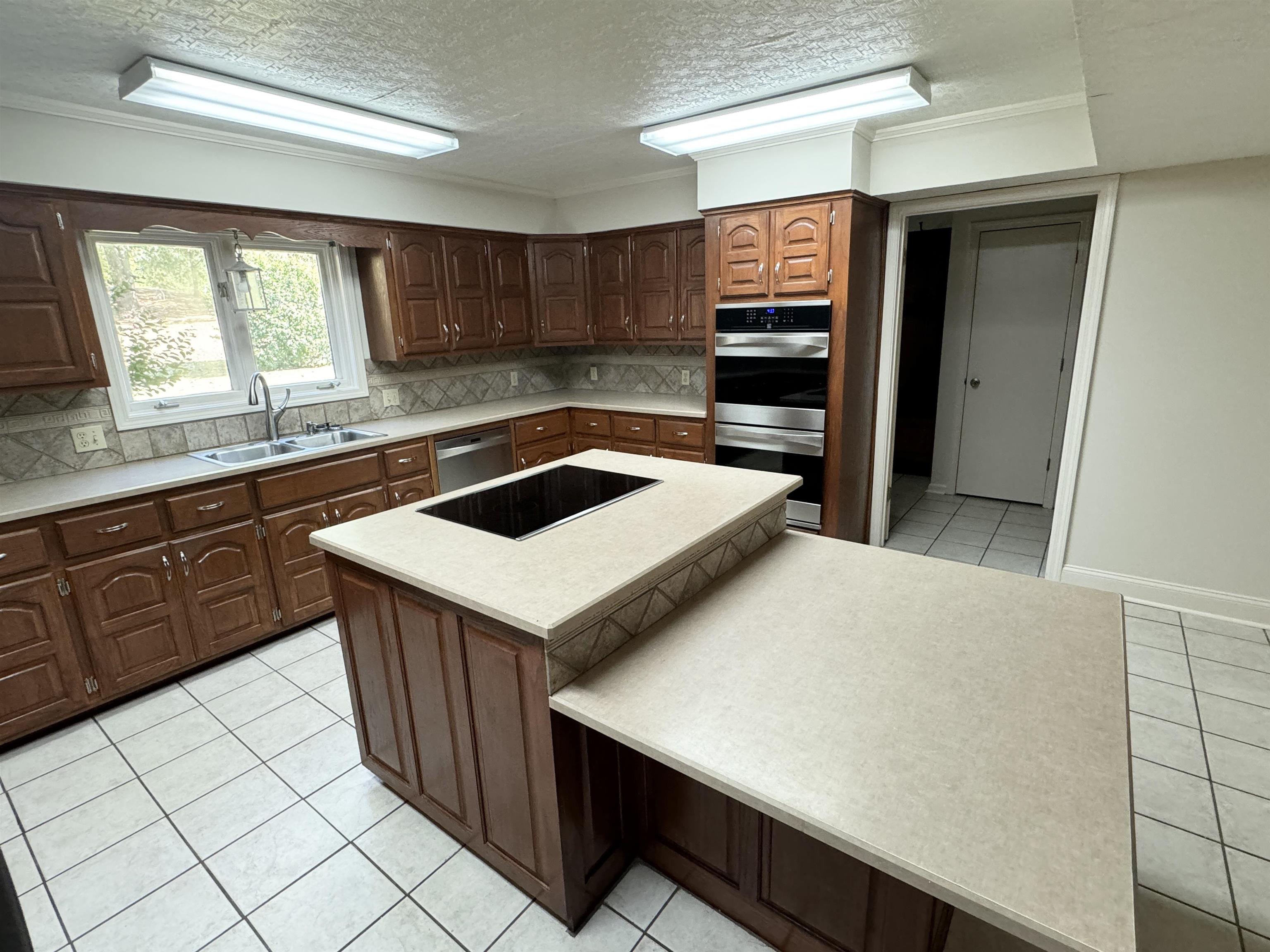 20 Tonya Drive Ripley, TN 38063 - Photo 11 of 33 a kitchen with a sink a stove and cabinets