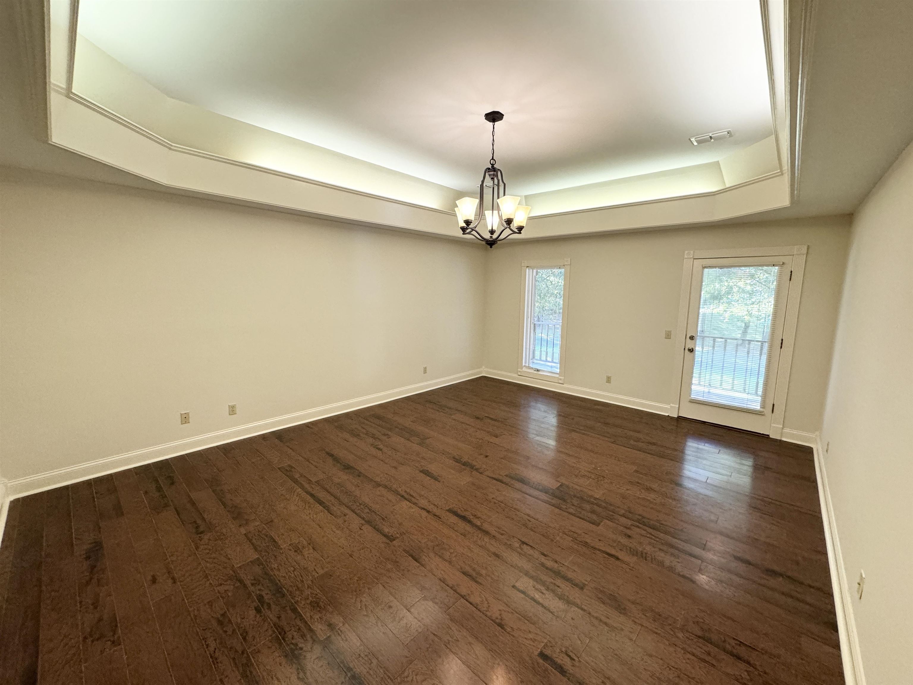 20 Tonya Drive Ripley, TN 38063 - Photo 19 of 33 an empty room with wooden floor chandelier and windows