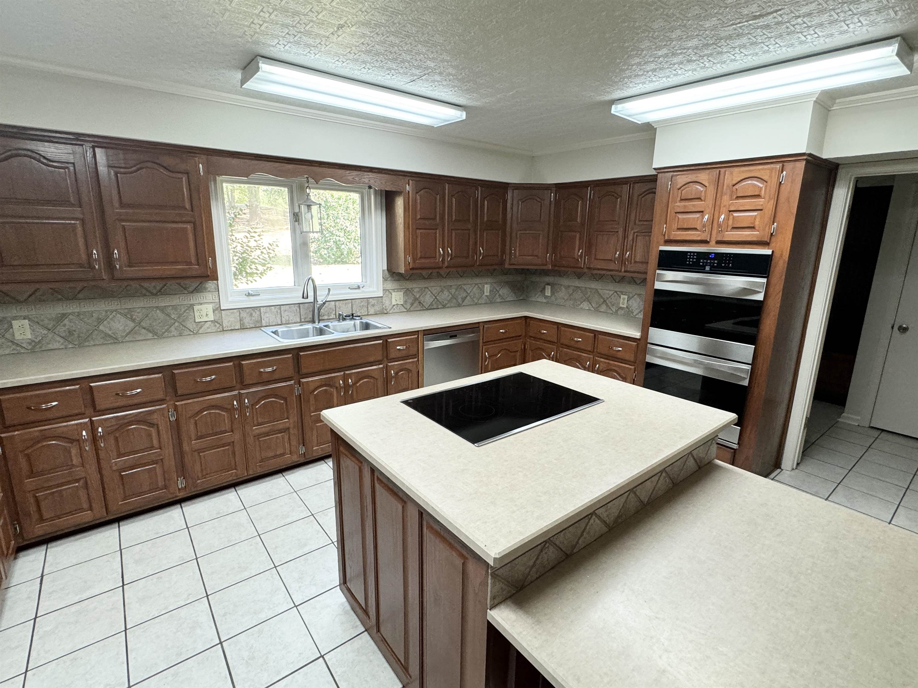 20 Tonya Drive Ripley, TN 38063 - Photo 8 of 33 a kitchen with a sink a stove and cabinets