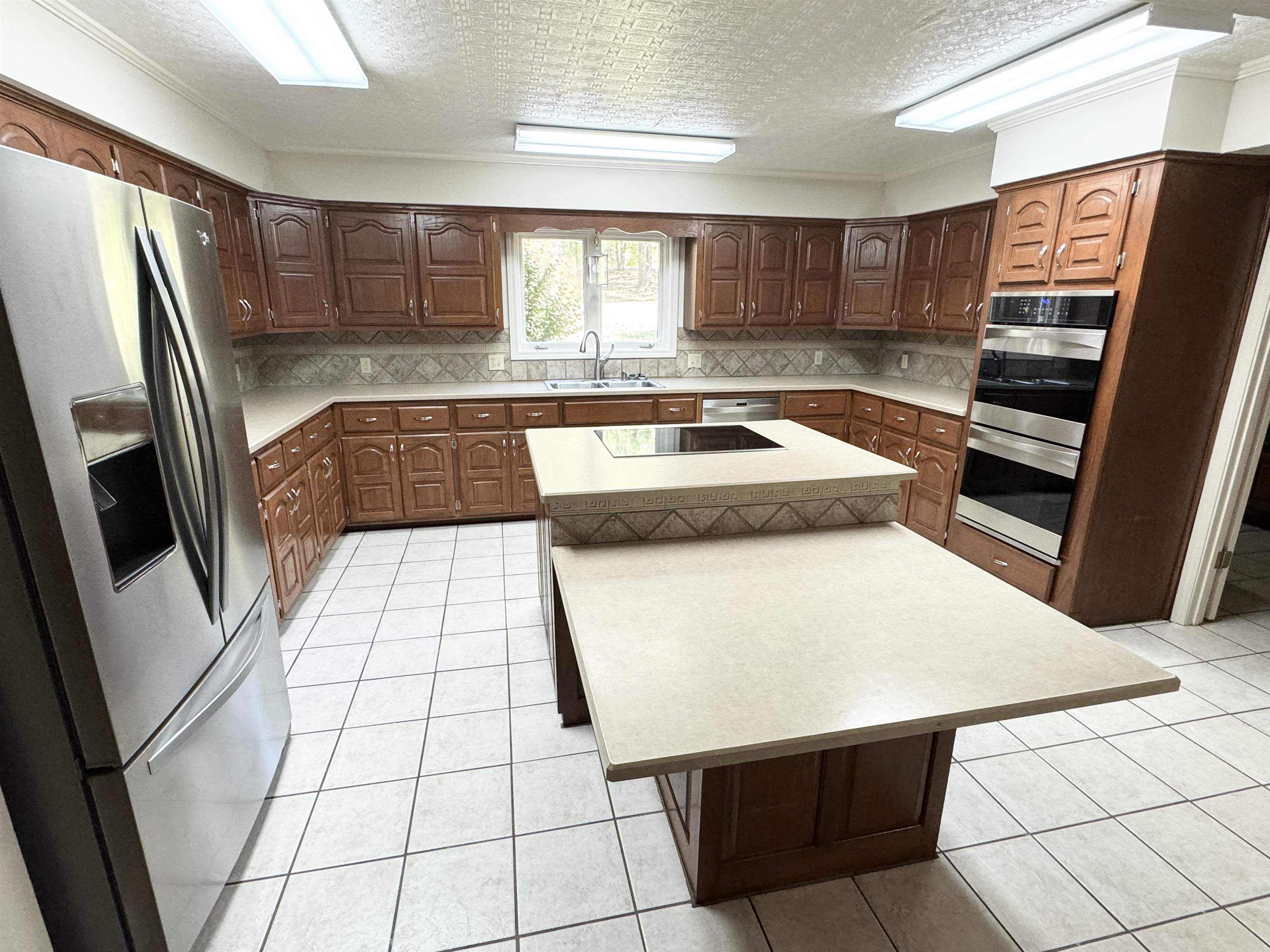 20 Tonya Drive Ripley, TN 38063 - Photo 9 of 33 a kitchen with stainless steel appliances a refrigerator sink and cabinets